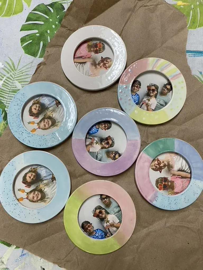 Campers holding framed art projects